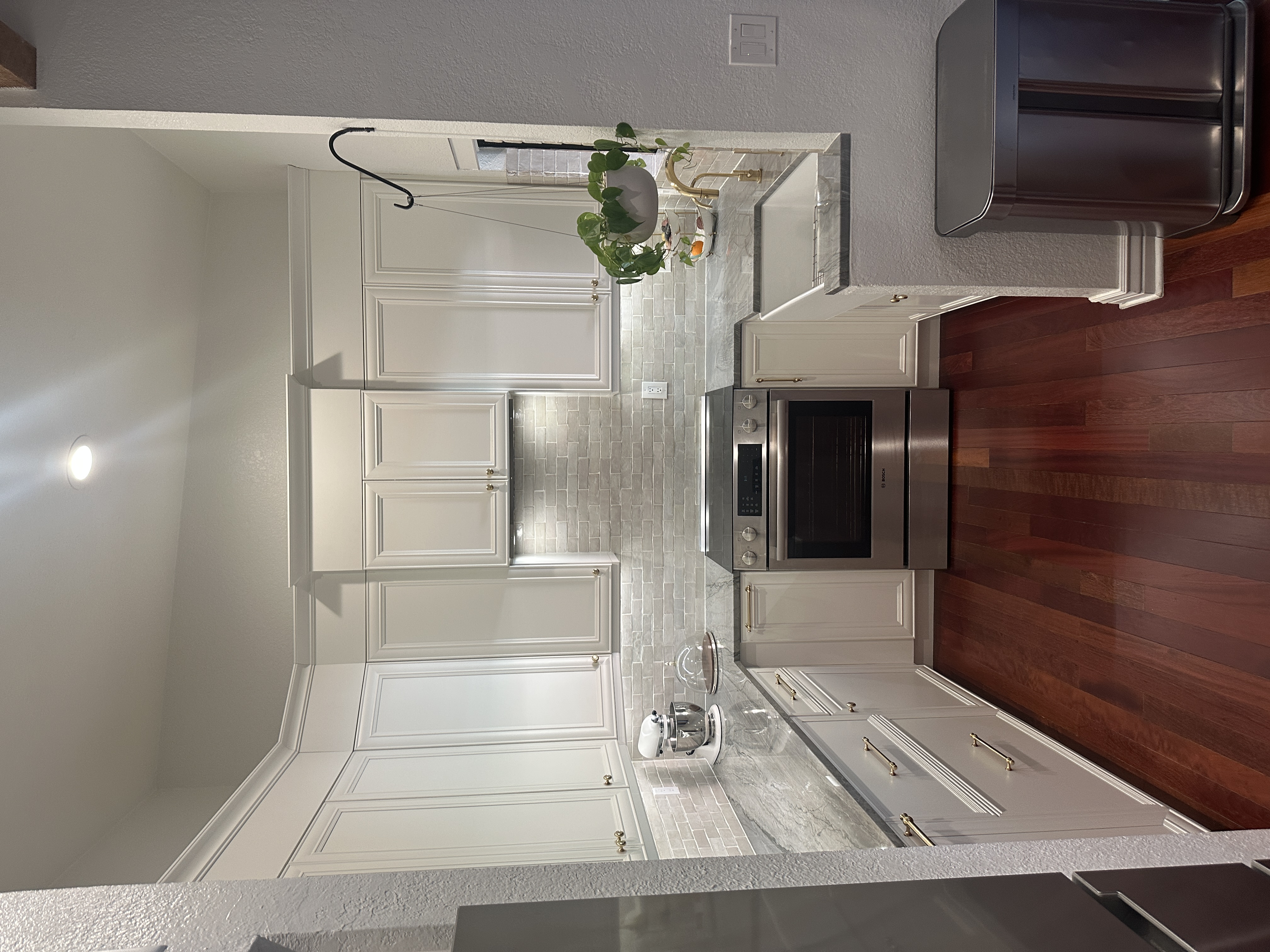 Custom kitchen remodel with white cabinets and marble countertops